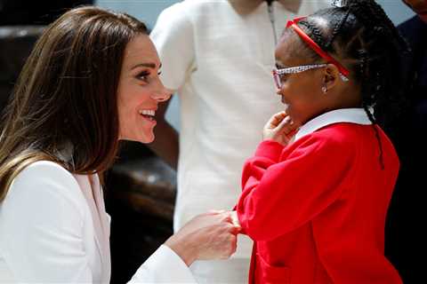 Touching moment Kate Middleton crouches down to shake hands with kids at Windrush Monument unveiling