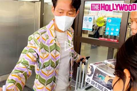 Squid Game Star Lee Jung-Jae Signs Funko Pop Figures For Fans In A Gucci Adidas Fit At LAX Airport