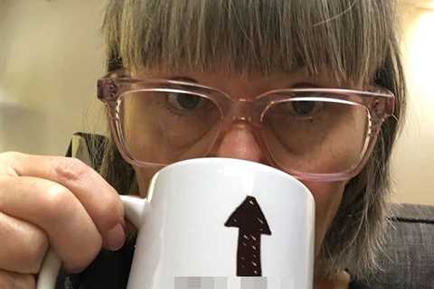 Dawn French is unrecognisable with grey fringe as she sips from rude mug