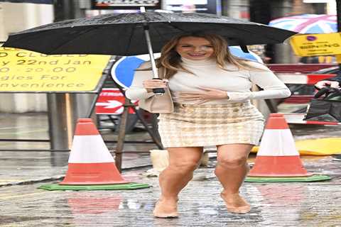 Amanda Holden goes braless and grabs her chest as she’s caught in the rain in London