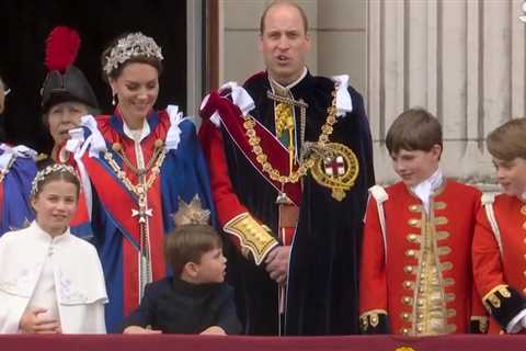 Adorable moment Prince Louis leans over to chat to big brother George as they brave rain on..