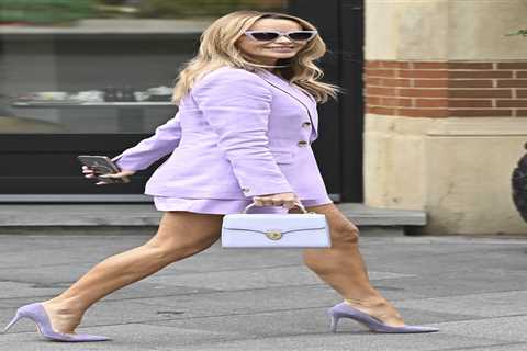 Amanda Holden goes braless and shows off her tanned legs in lilac mini-suit