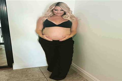 Towie’s Danielle Armstrong shows off her huge baby bump as she poses in a bra