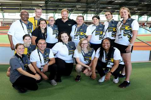 Prince Harry beams in pic with Invictus volunteers in Germany a day after tribute to the Queen..