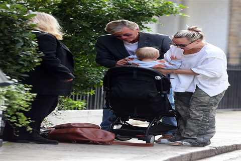 Richard Madeley showcases his doting grandfather side as he cuddles baby Bodhi on a family outing