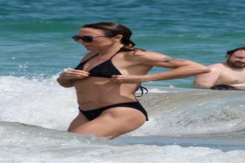 Mel C flaunts washboard abs in black bikini as she hits the beach in Ibiza