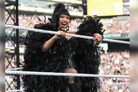 Cardi B Stuns in Custom Black Feather Corset, Dramatic Cape, and Le Silla Boots for WWE Performance ..