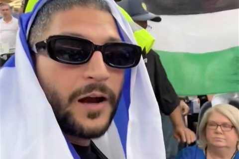 Moment Israeli flag-waving fan ejected from World Cup game — as Palestinian flag allowed to stay