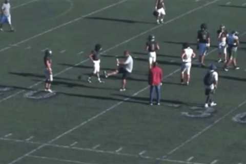 Moment raging high school football coach blasts ball into youngster’s crotch